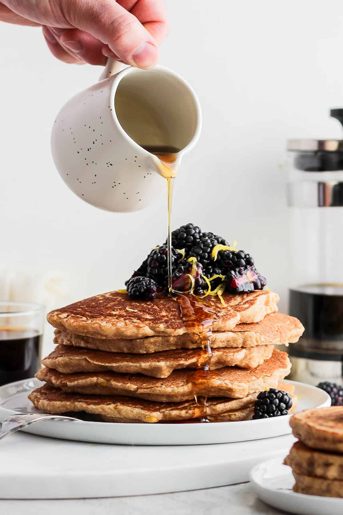 pouring syrup on pancakes.