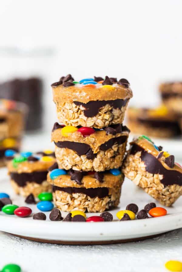 Monster cookie oat cups stacked on a plate.