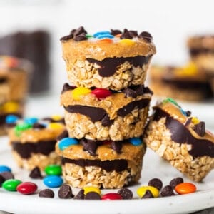 Monster cookie oat cups stacked on a plate.