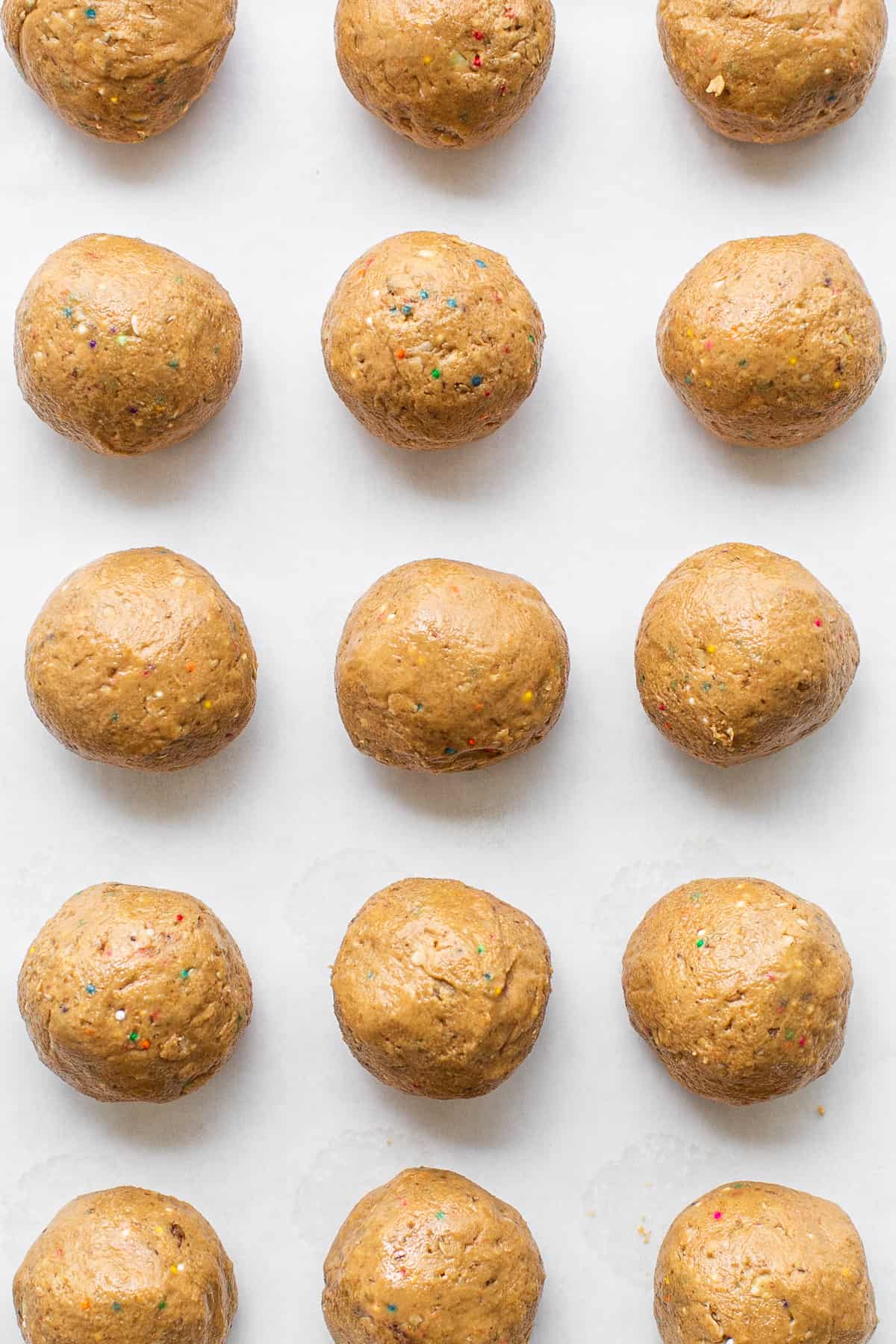 Protein cake pop balls on a cookie sheet.