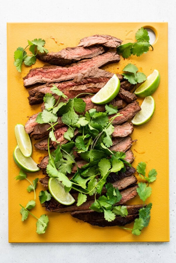 Sliced steak on a cutting board.