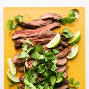 Sliced steak on a cutting board.