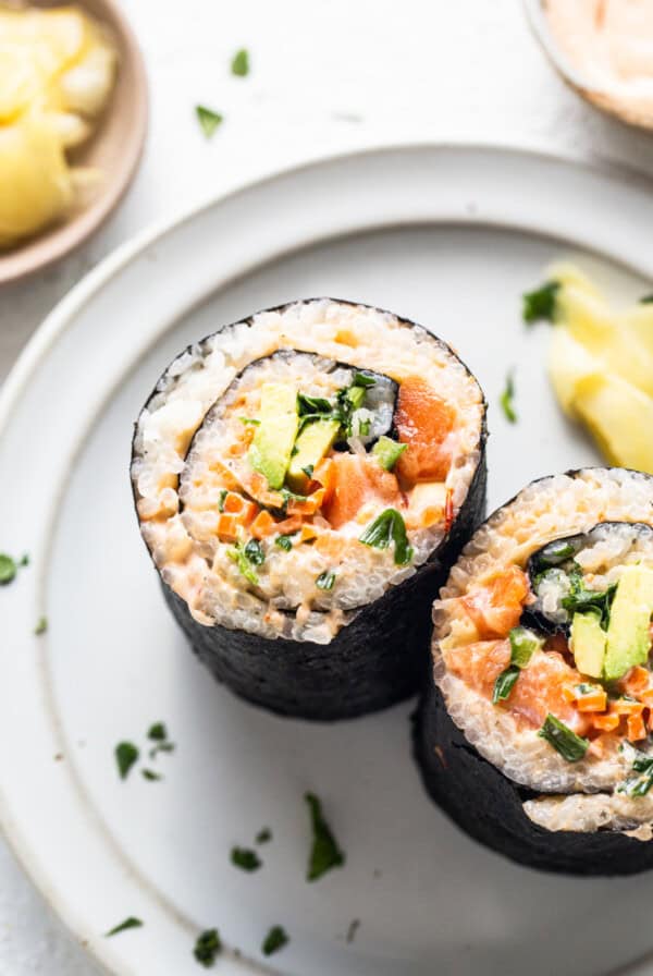 a white plate topped with sushi next to a pineapple.