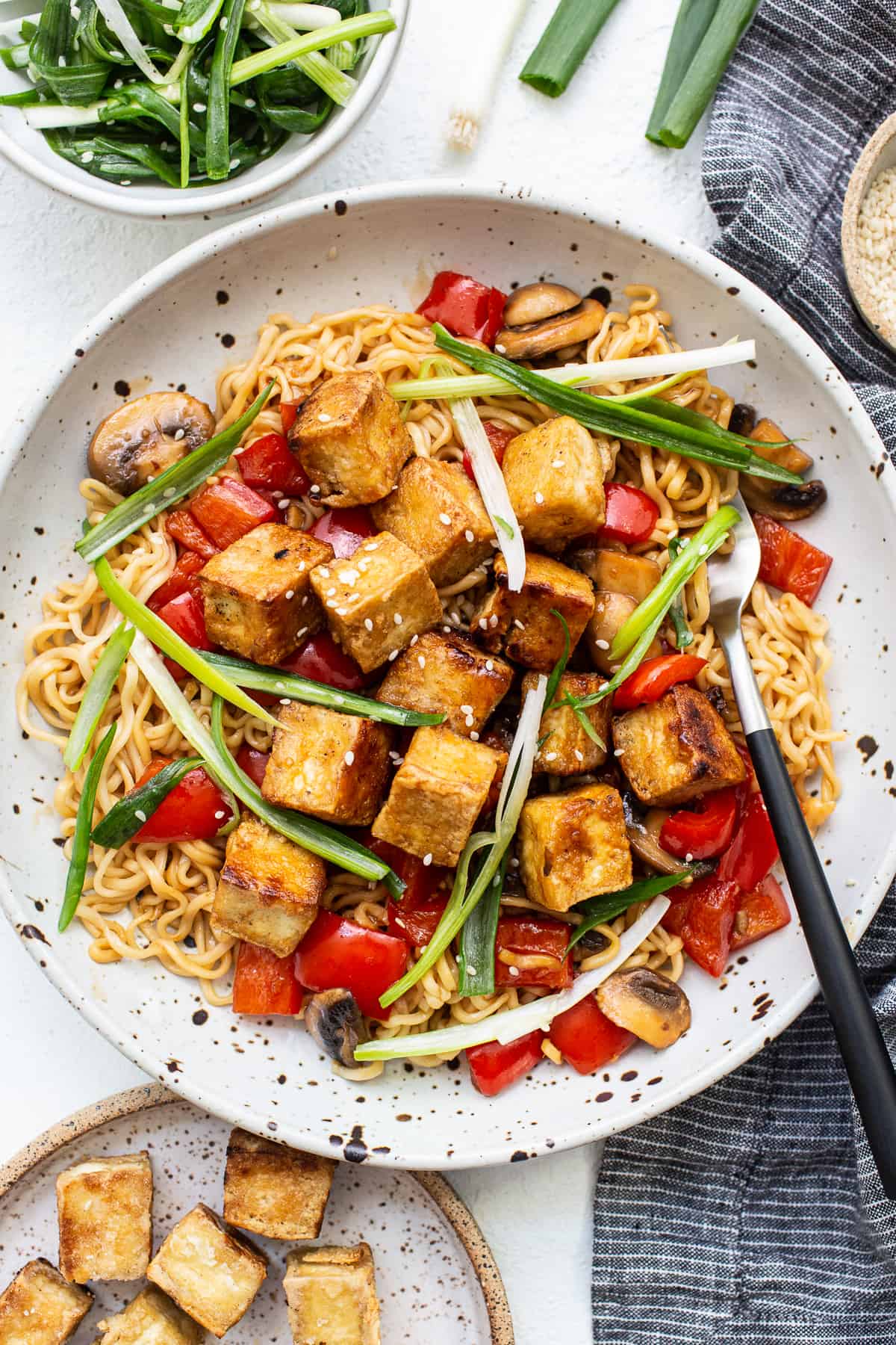 Tofu stir fry in a white plate.