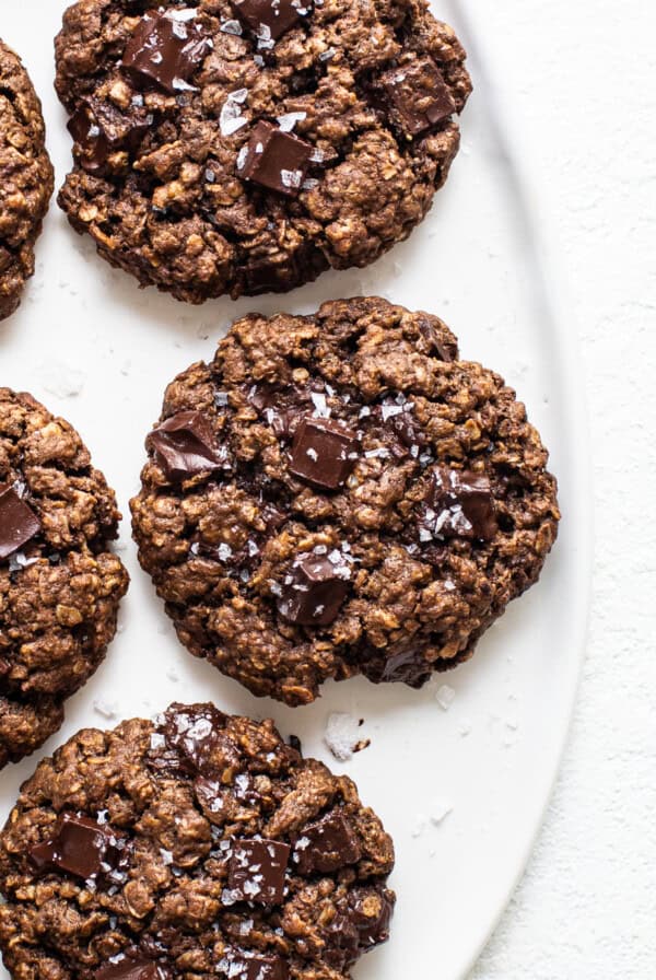 Chocolate oatmeal cookies on a white plate.