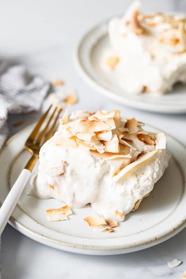 a white plate topped with a piece of cake.