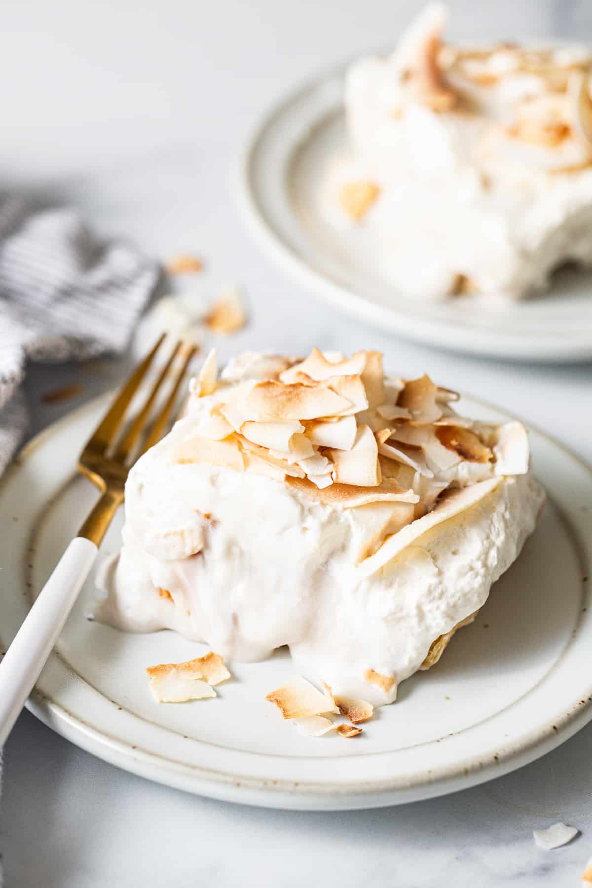 a white plate topped with a piece of cake.