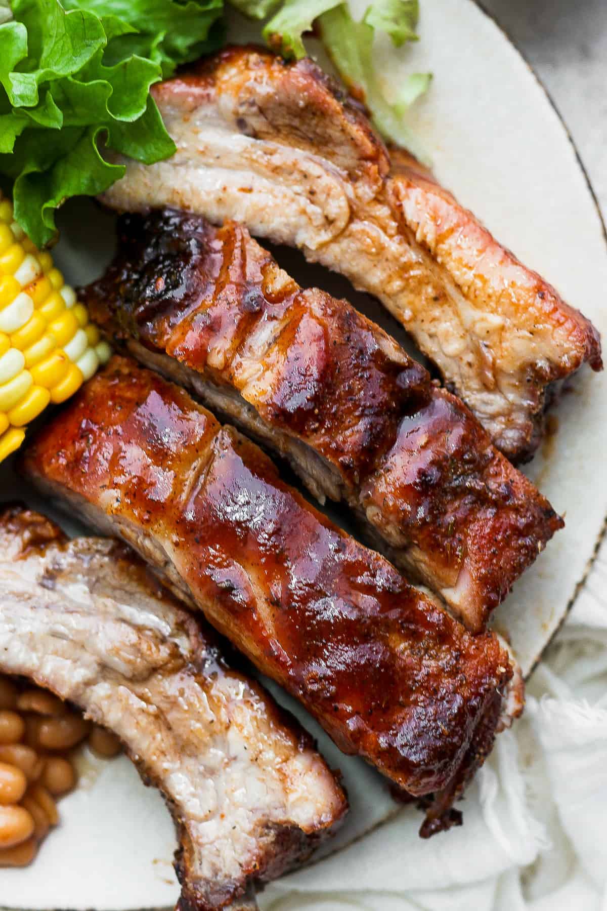 Dry rubbed ribs on a plate.