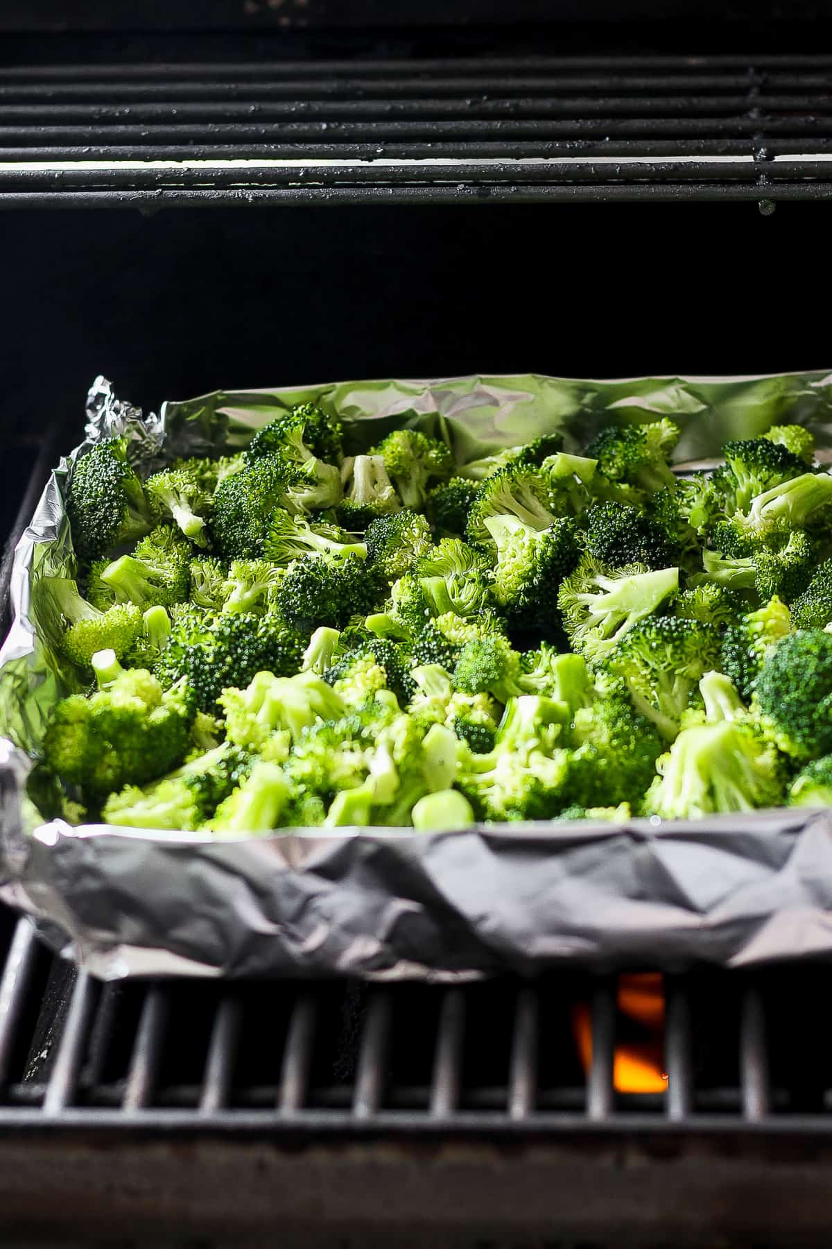 a tray of broccoli is cooking in an oven.