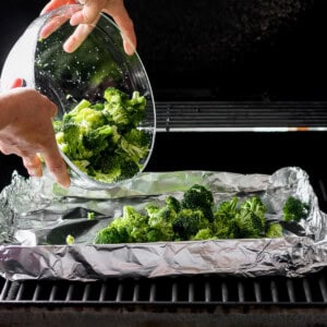 a person is putting broccoli in a bowl.