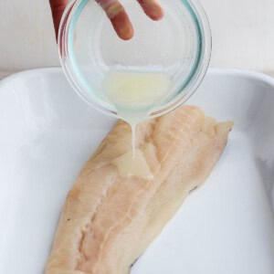 Marinade being poured over fish.