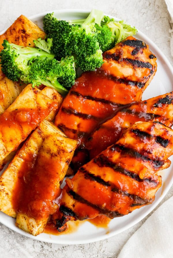 a white plate topped with chicken and broccoli.