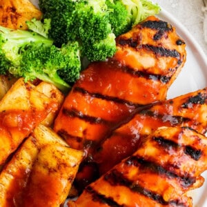 a white plate topped with chicken and broccoli.