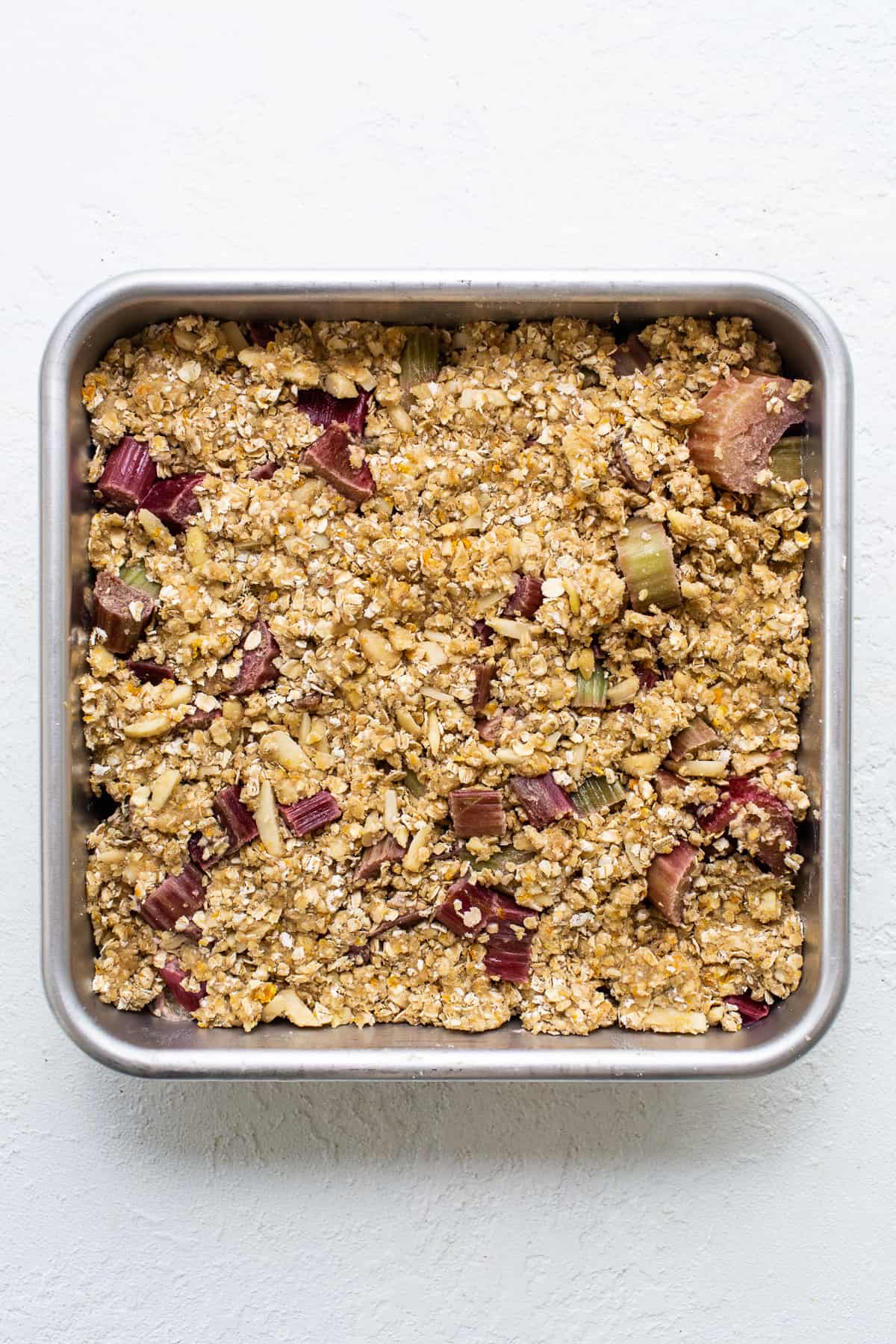 A metal pan with granola in it.