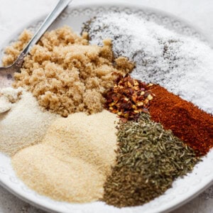 a white plate topped with different types of spices.