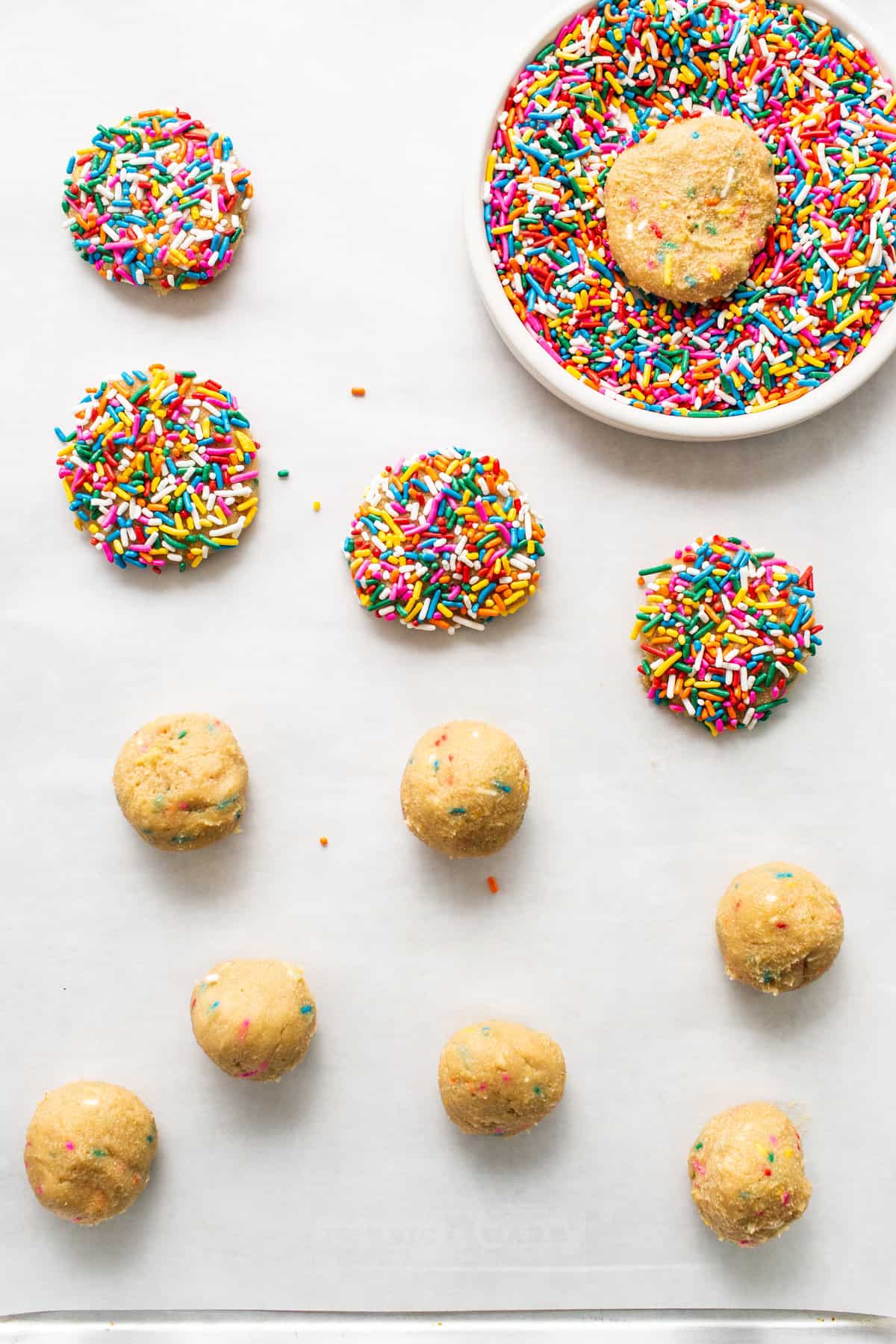 dipping cookies in sprinkles.