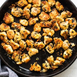 Chicken nuggets in a skillet with a towel.