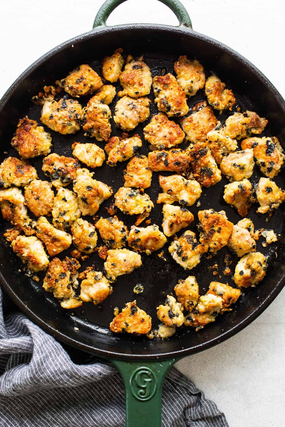 Pan searing chicken in a skillet. 