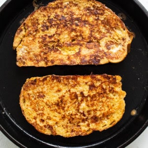 Two slices of french toast in a skillet.