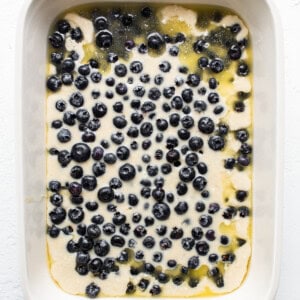 uncooked blueberry cobbler in n baking dish.