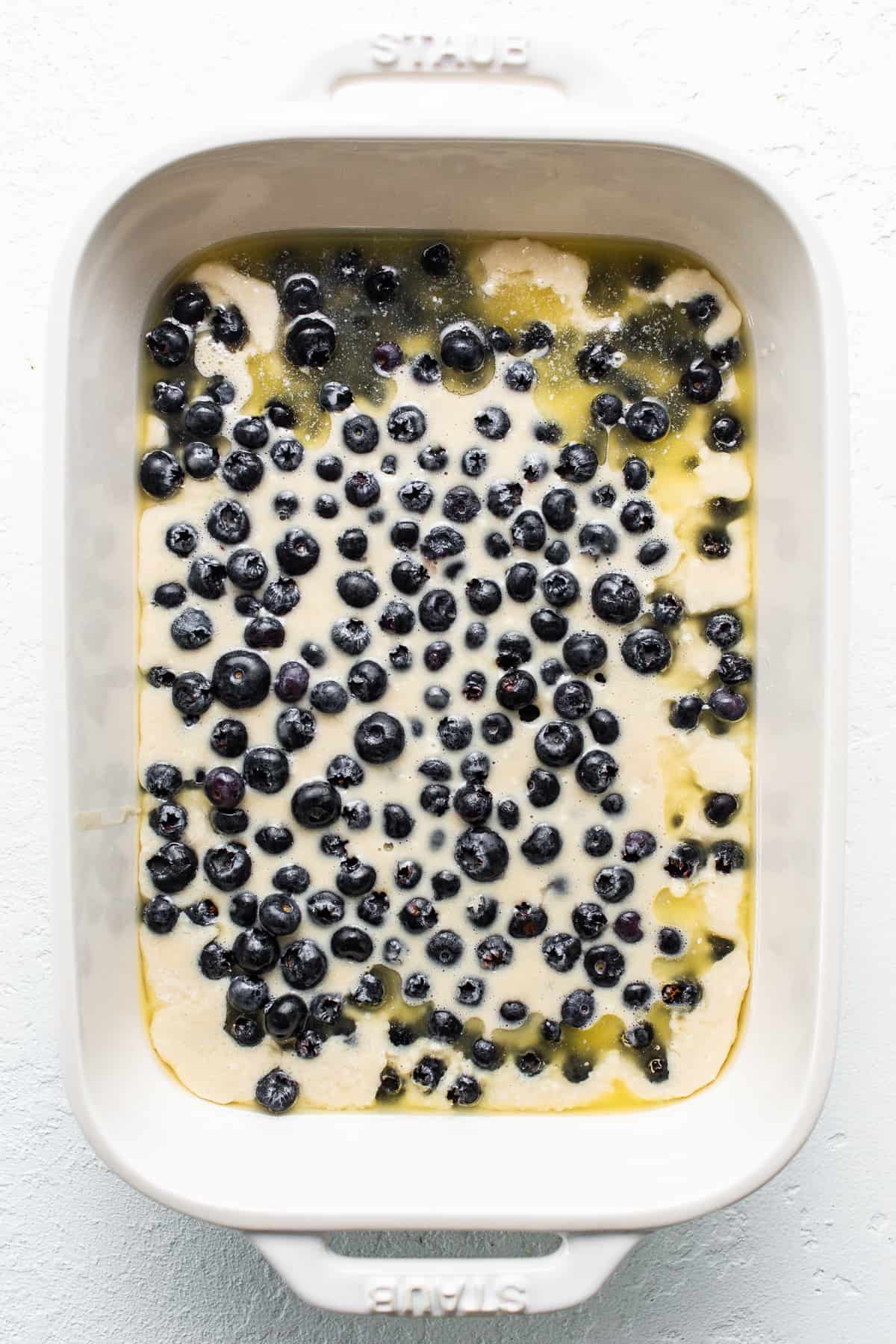 uncooked blueberry cobbler in n baking dish.