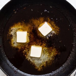 A frying pan with butter in it.