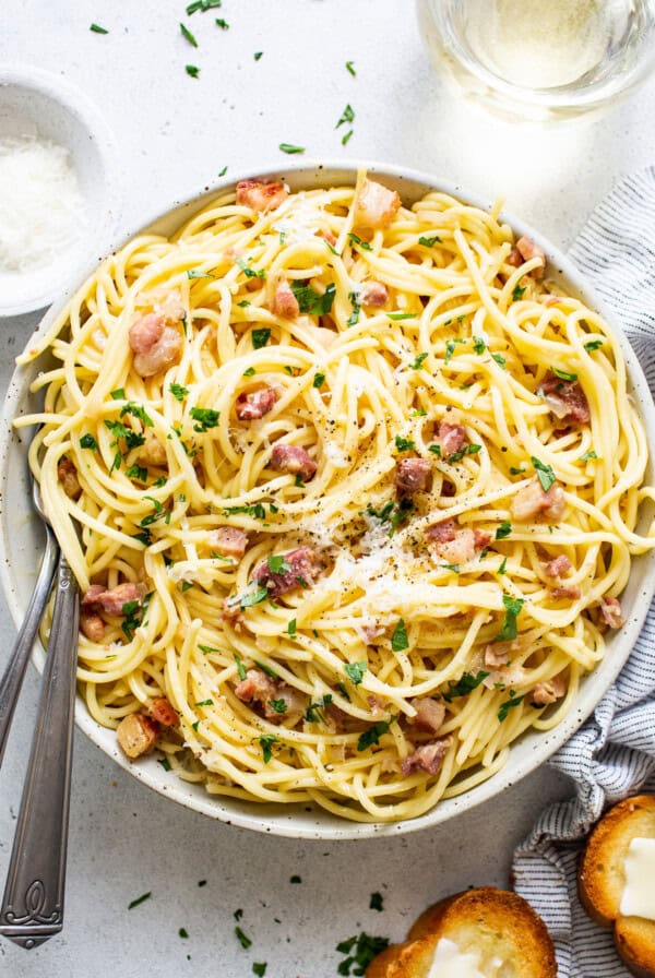 A bowl of spaghetti with bacon and parmesan.