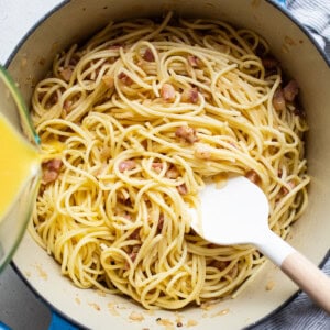 A pot of spaghetti with bacon and orange juice.