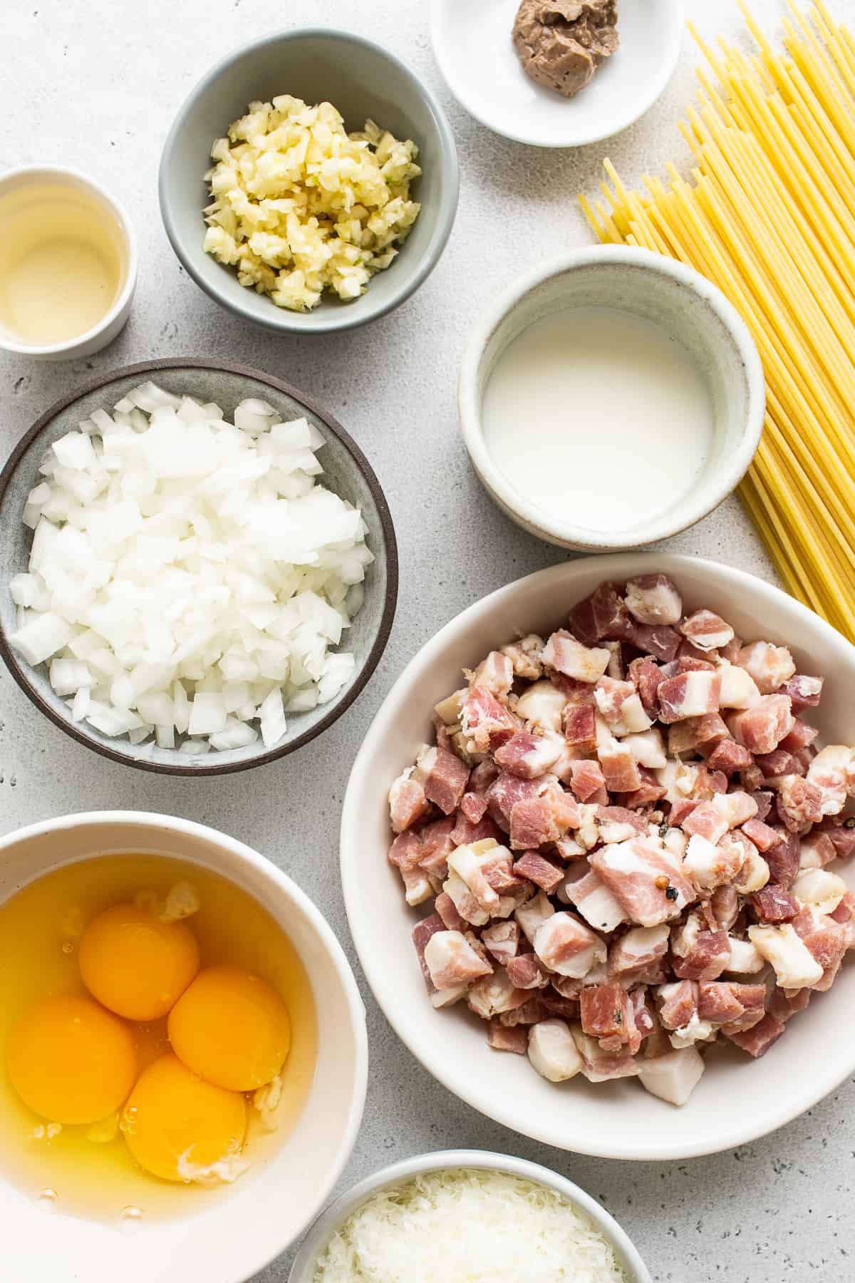 Ingredients for spaghetti and meatballs on a white background.