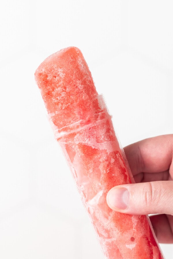 hand holding wine freezie pop.