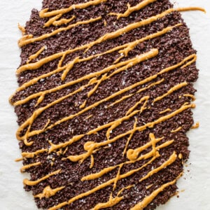 a piece of chocolate cake with caramel drizzle on top.