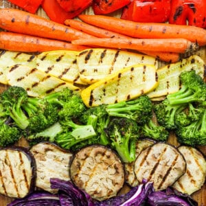 a variety of vegetables laid out on a cutting board.