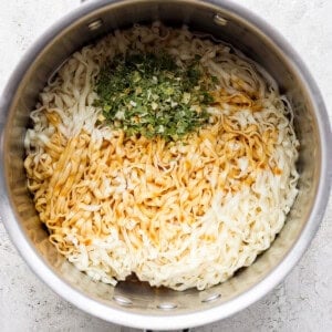 a pan with rice and herbs in it.