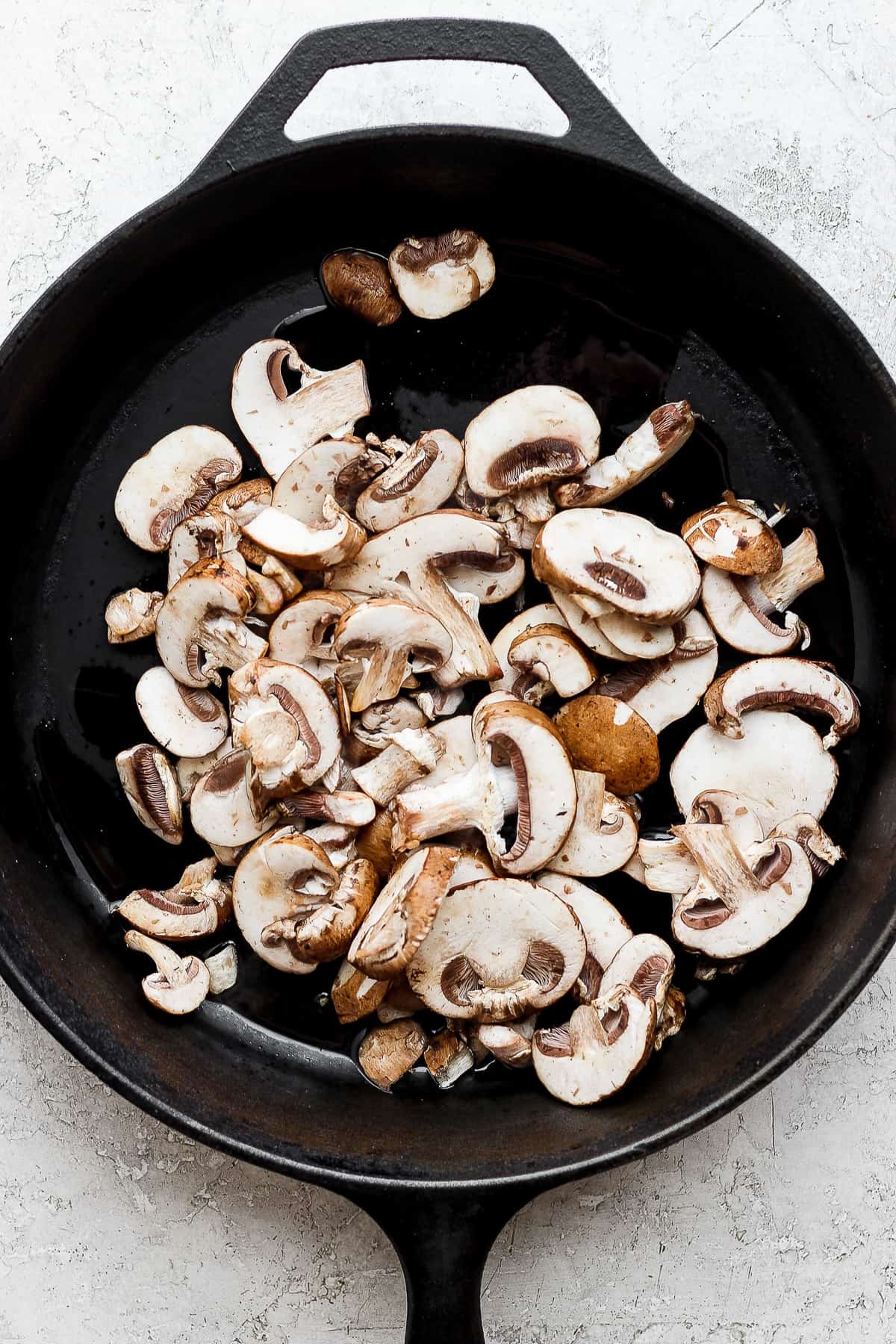 mushrooms in a skillet on a white background.