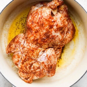 roasted chicken in a skillet on a white background.