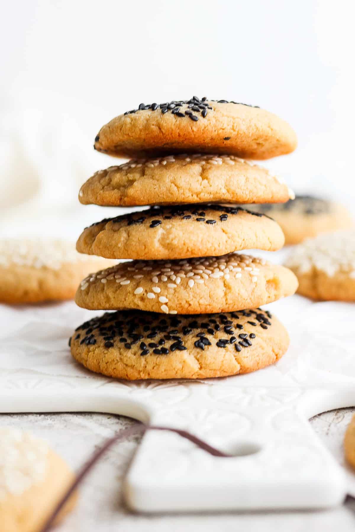 a stack of cookies with sesame seeds on top.