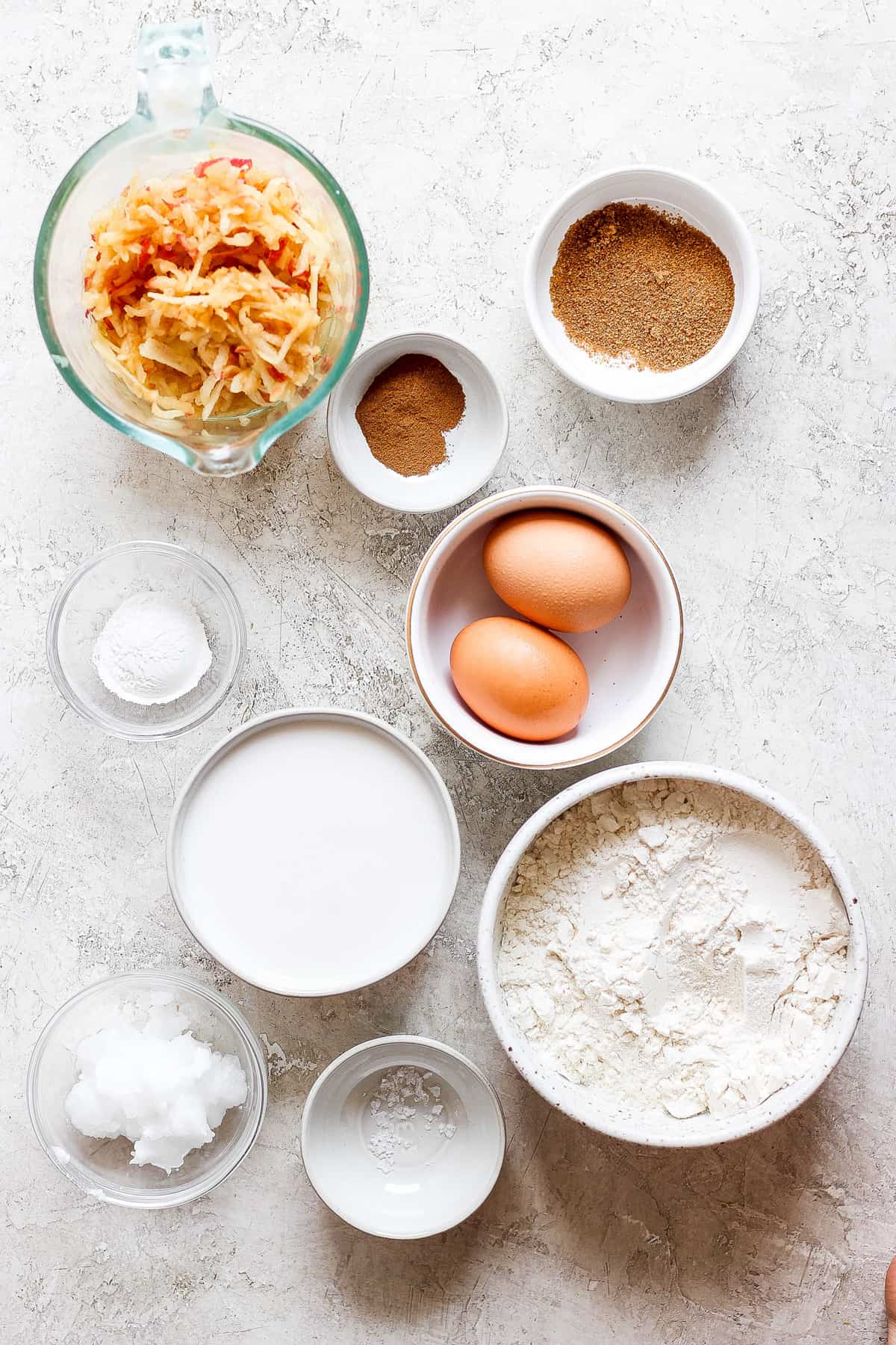 eggs, flour, sugar, and other ingredients are shown on a table.