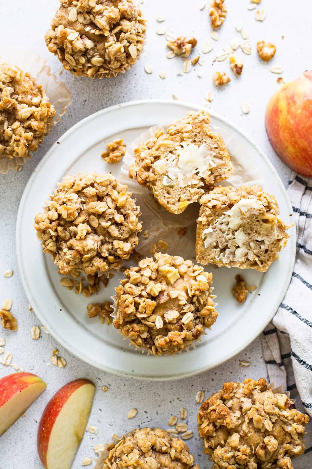 oatmeal apple muffins on a plate with apples.