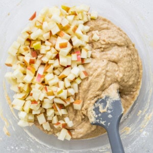 apples in a bowl with a spatula.