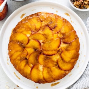 peach upside down cake on a white plate.