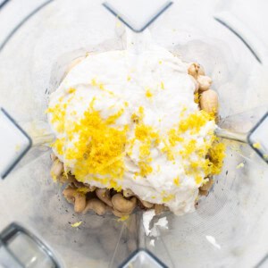 a food processor filled with lemons and nuts.