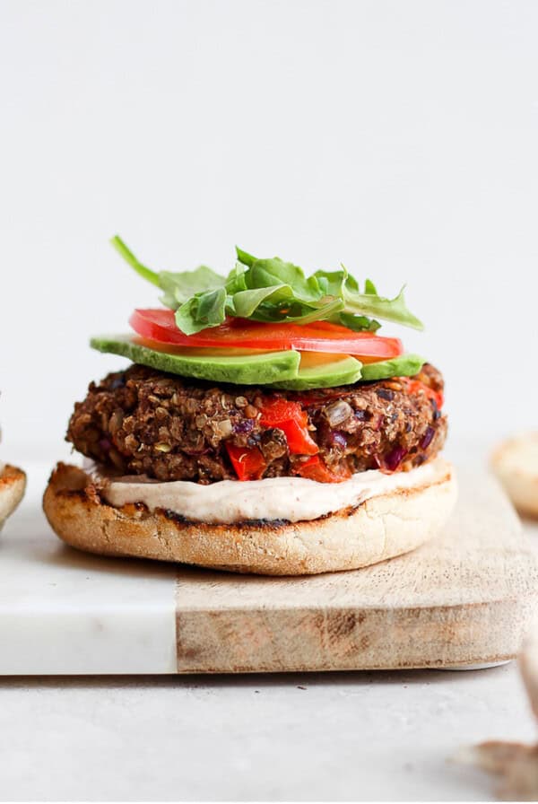 Two black bean veggie burgers on a cutting board.