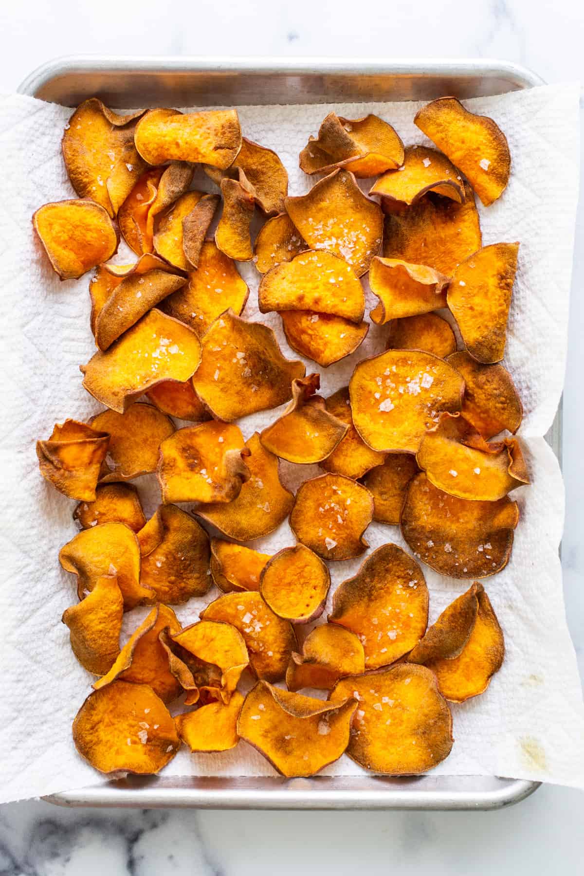 Sweet potato chips on a baking sheet.