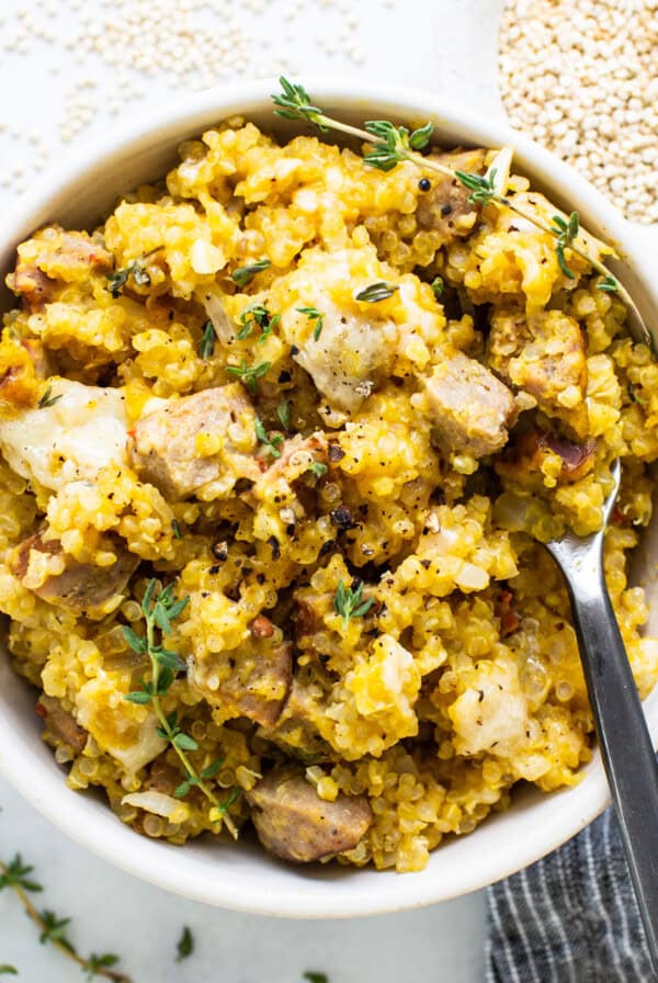 A bowl of rice with meat and herbs.