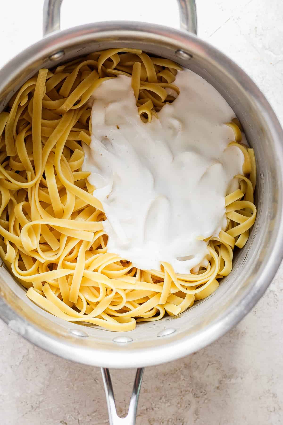 A pot of pasta with cream in it.