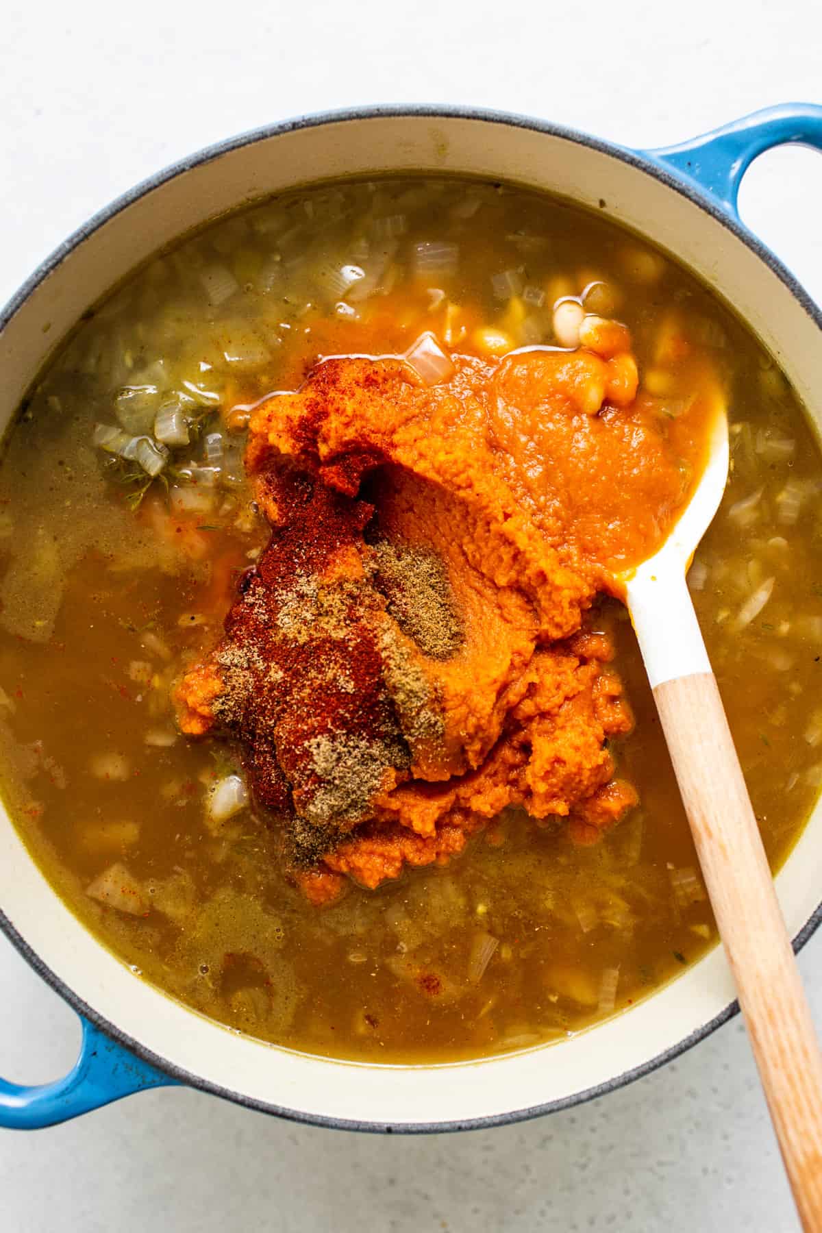 A pot of soup with a spoon in it.