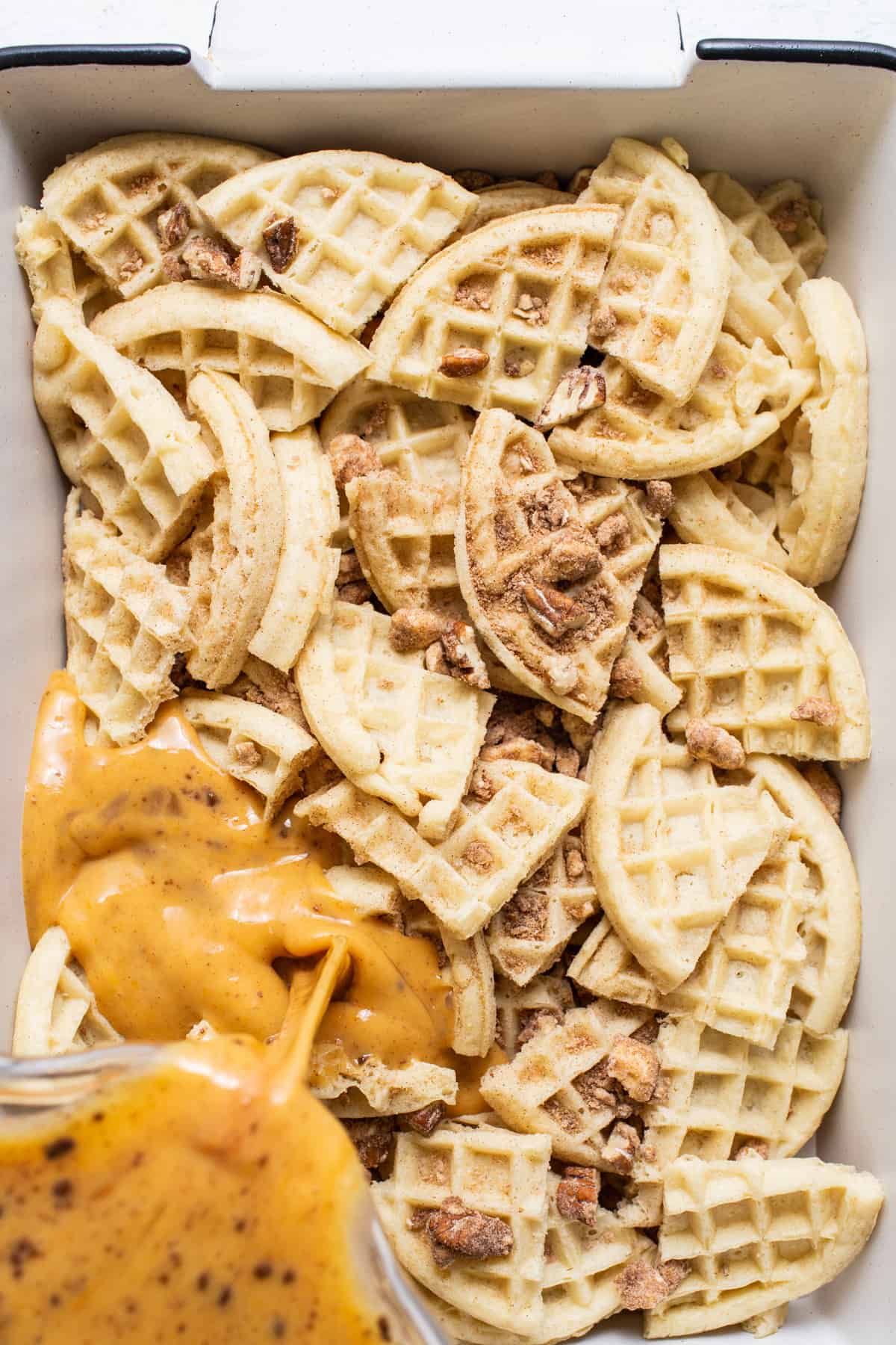 Waffles in a white baking dish with sauce.