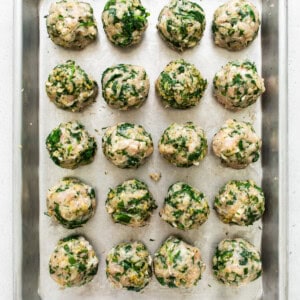 Spinach and mushroom meatballs on a baking sheet.