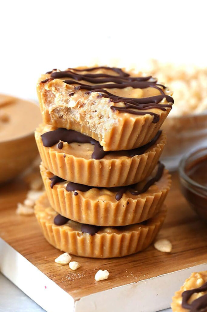 A stack of peanut butter cups on a cutting board.