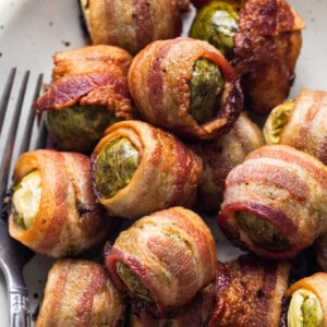 Bacon wrapped brussels sprouts on a plate.